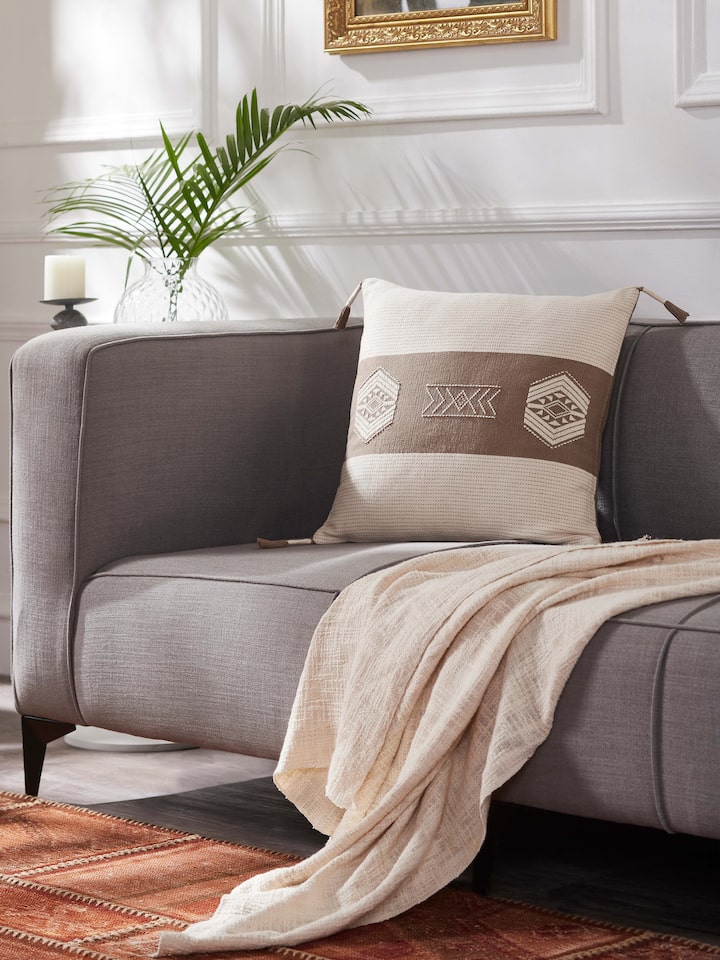 Close-up of Ridhama khakhi barnava cotton Naga handloom cushion cover highlighting the handloom fabric