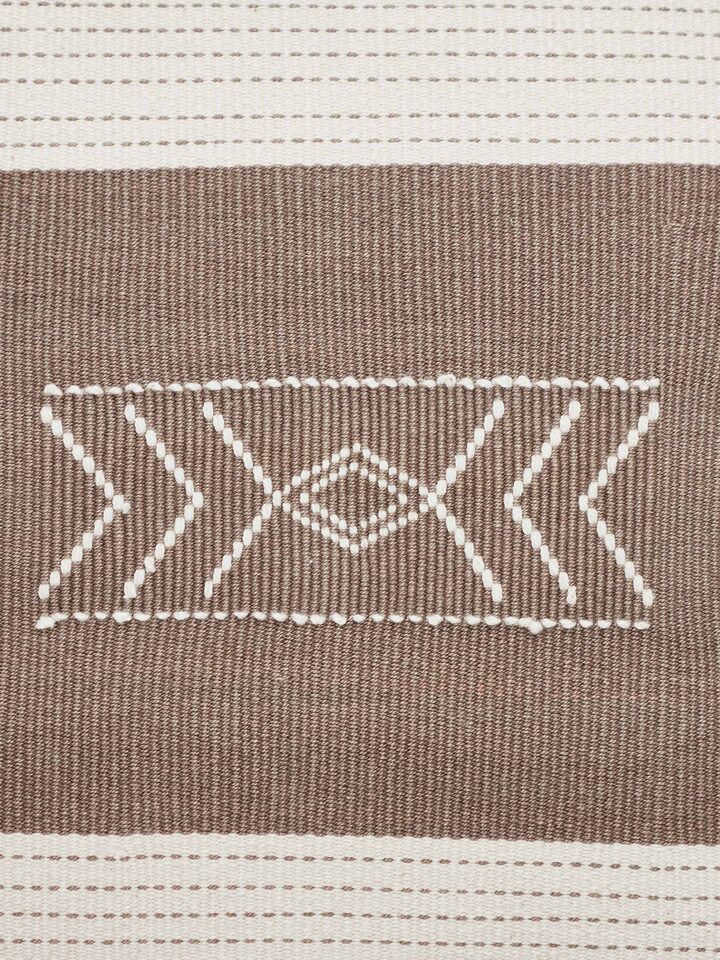 Side view of Ridhama khakhi barnava cotton Naga handloom cushion cover emphasizing its handloom texture