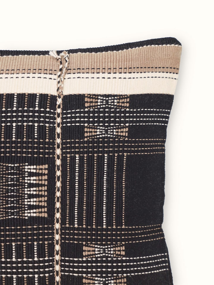 Detailed view of Ridhama Black Mrunal Cotton Naga Handloom Cushion Cover, emphasizing the fabric's weave and craftsmanship.