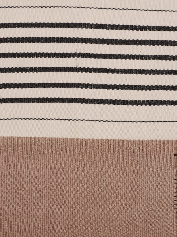 Close-up of handloom texture and weave of khaki cotton Naga cushion cover.