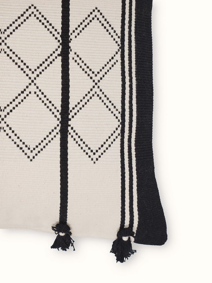Angled view highlighting the textured pattern and fine cotton weave of the Naga handloom cushion cover
