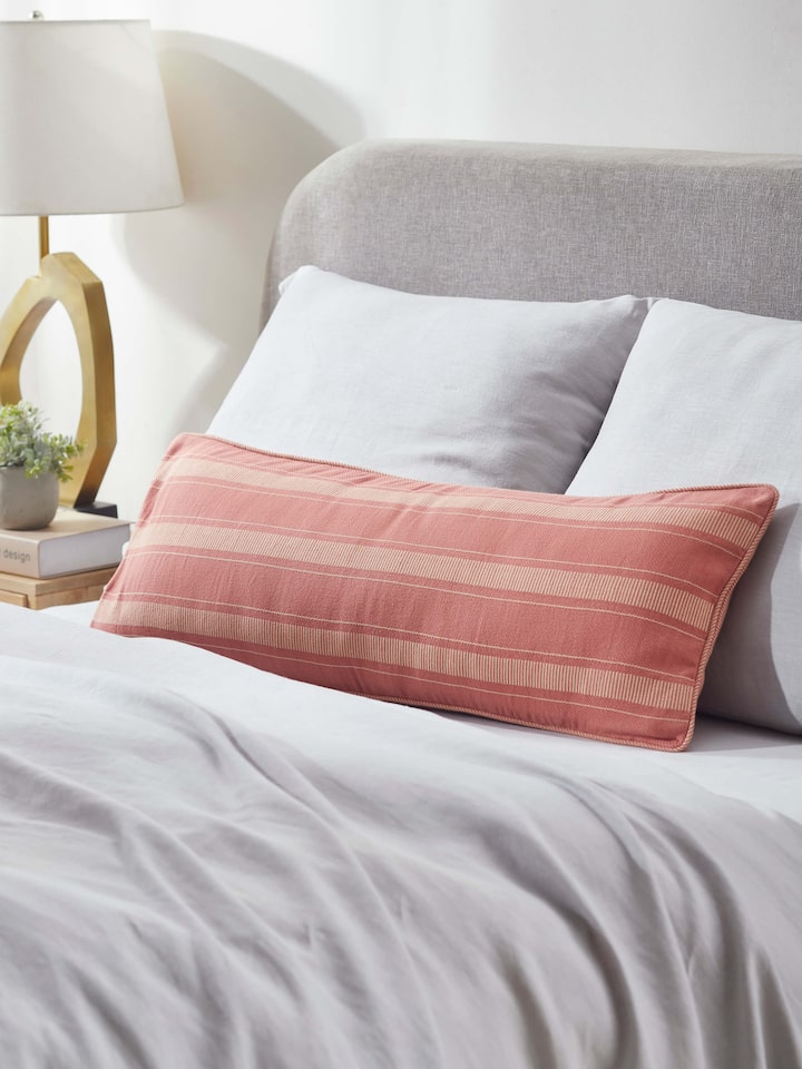 Detailed view of Godna peach stripe cotton handwoven pattu cushion cover highlighting the peach stripe pattern and fabric quality.