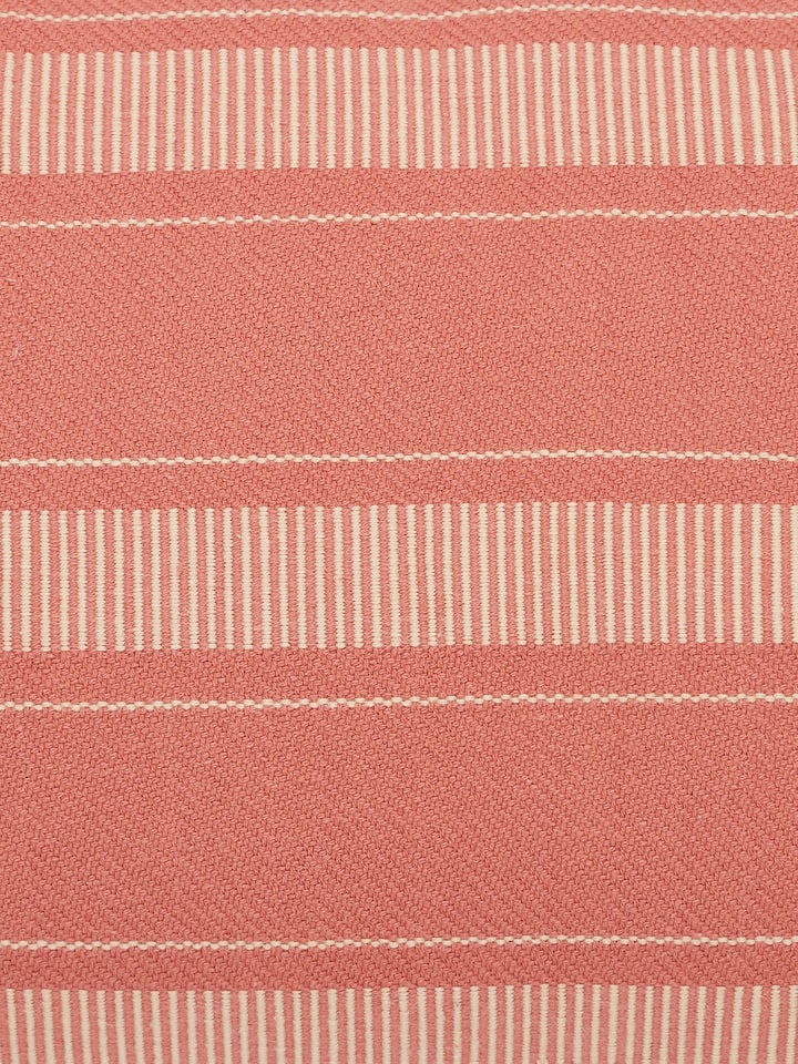 Detailed view of Godna peach stripe cotton handwoven pattu cushion cover showing the texture and color of the fabric.
