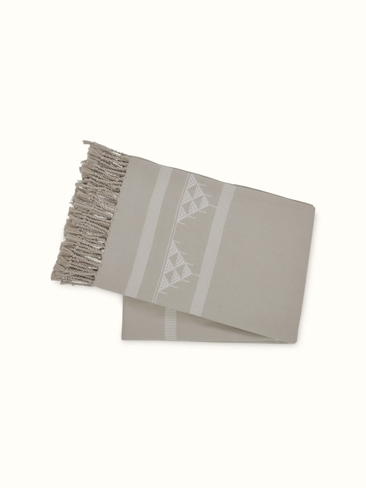 Back view of the Godna beige Pattu throw showcasing the full stripe layout.