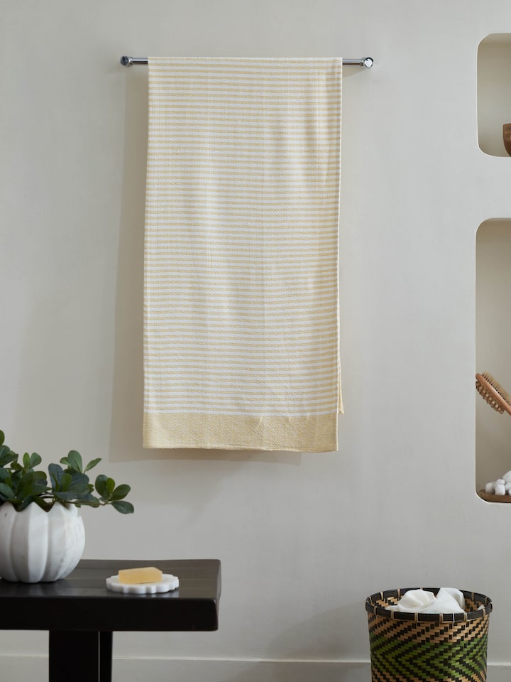 Close-up of Vayana solid yellow cotton bath towel (XL) highlighting the soft cotton texture and vibrant yellow shade