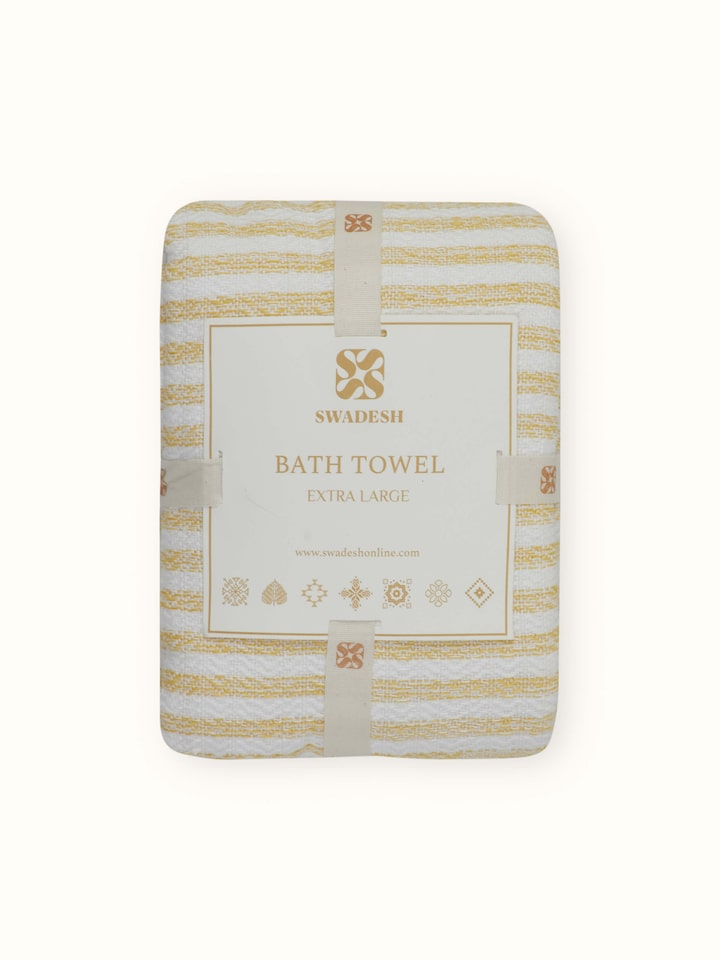 Close-up of Vayana solid yellow cotton bath towel (XL) emphasizing the softness and absorbency of the cotton fabric