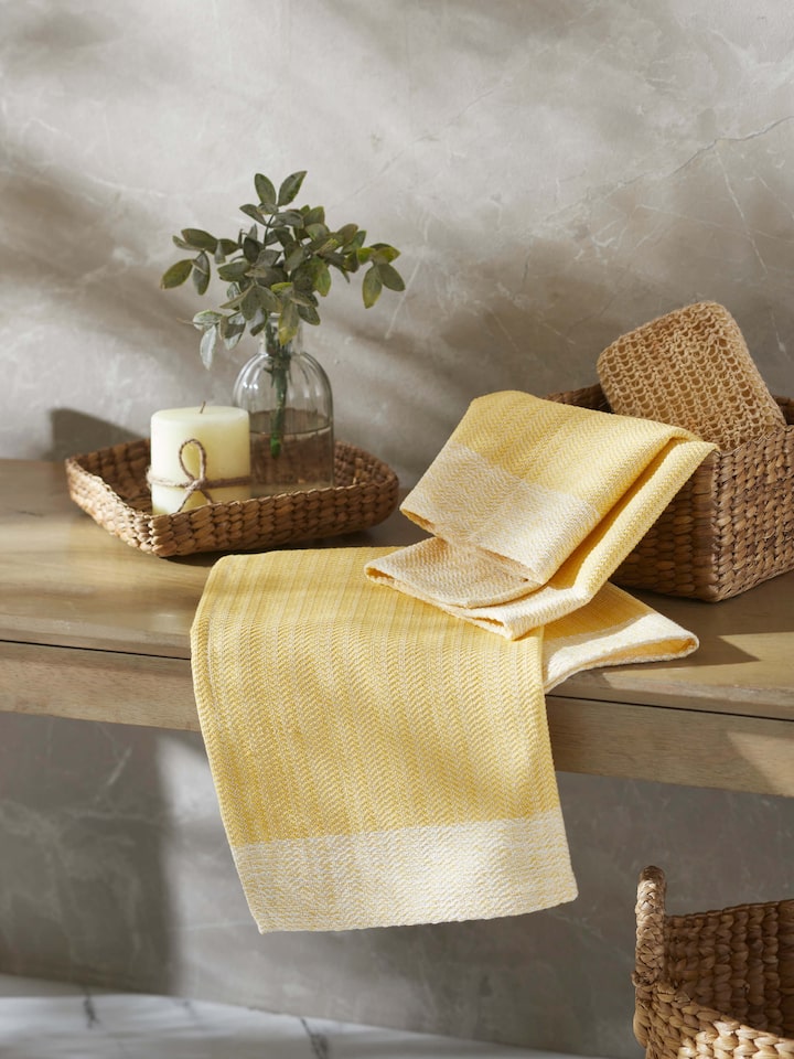 Close-up of Vayana solid yellow stripe cotton hand towel, showing the texture and stripe detail