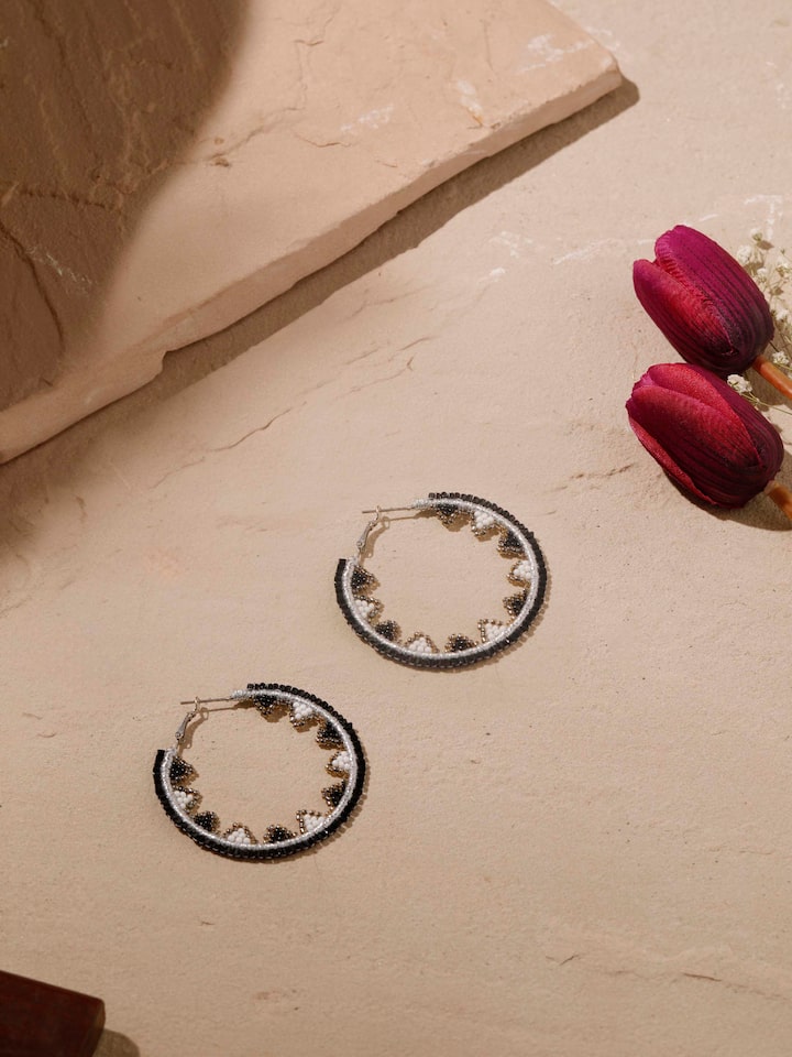 Close-up view of handcrafted hoop earrings highlighting fine detailing