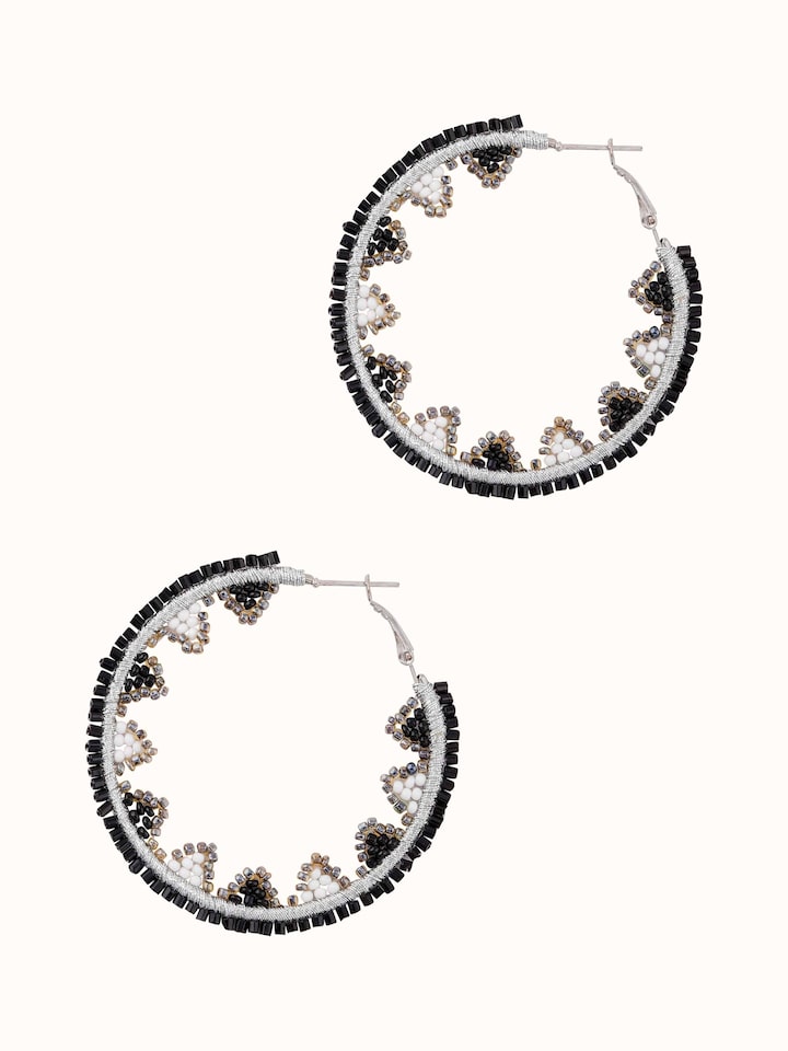 Detailed view of handcrafted hoop earrings with elegant design elements