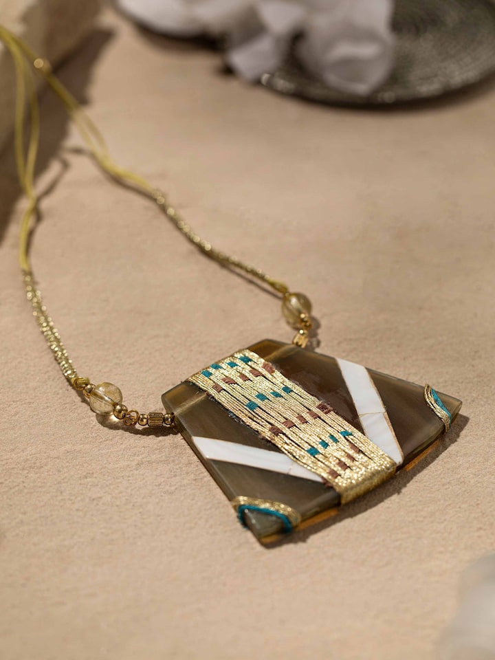Detailed view of handcrafted long necklace showcasing its fine craftsmanship and stylish design.