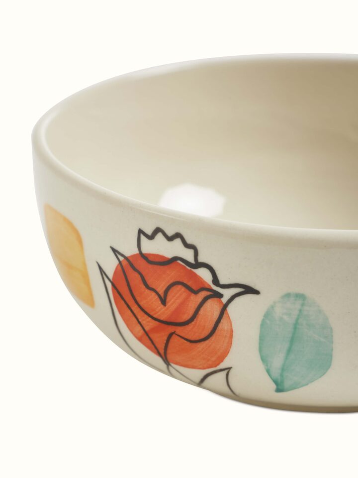 Close-up of Khurja pottery ceramic serving bowl in orange & white revealing intricate design patterns