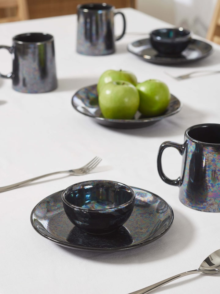 Side view of Khurja Pottery Ceramic Salad Plates in black, highlighting the sleek, curved edges and finish