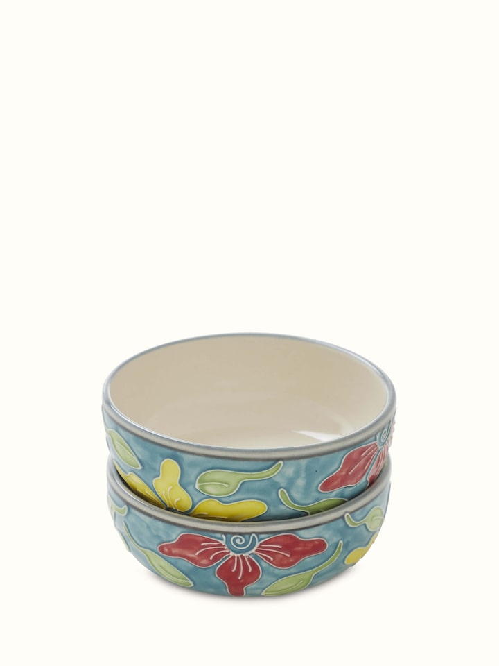 Close-up of Khurja pottery ceramic dinner bowls in blue and white, emphasizing intricate design details.
