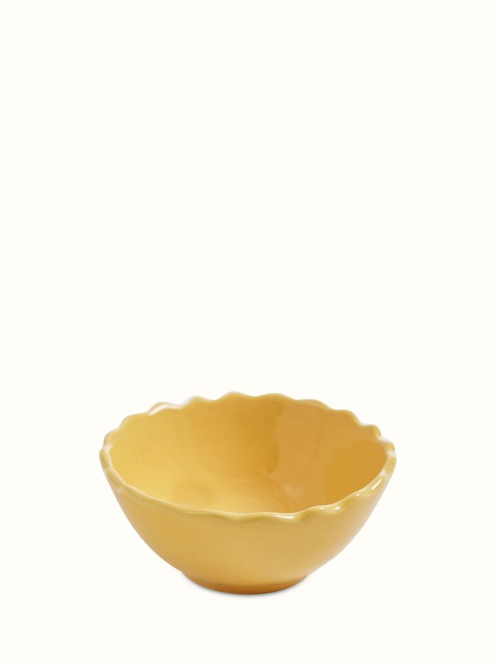 Close-up view of Khurja pottery ceramic dinner bowls in yellow, set of 4, focusing on the smooth finish and vibrant hue.