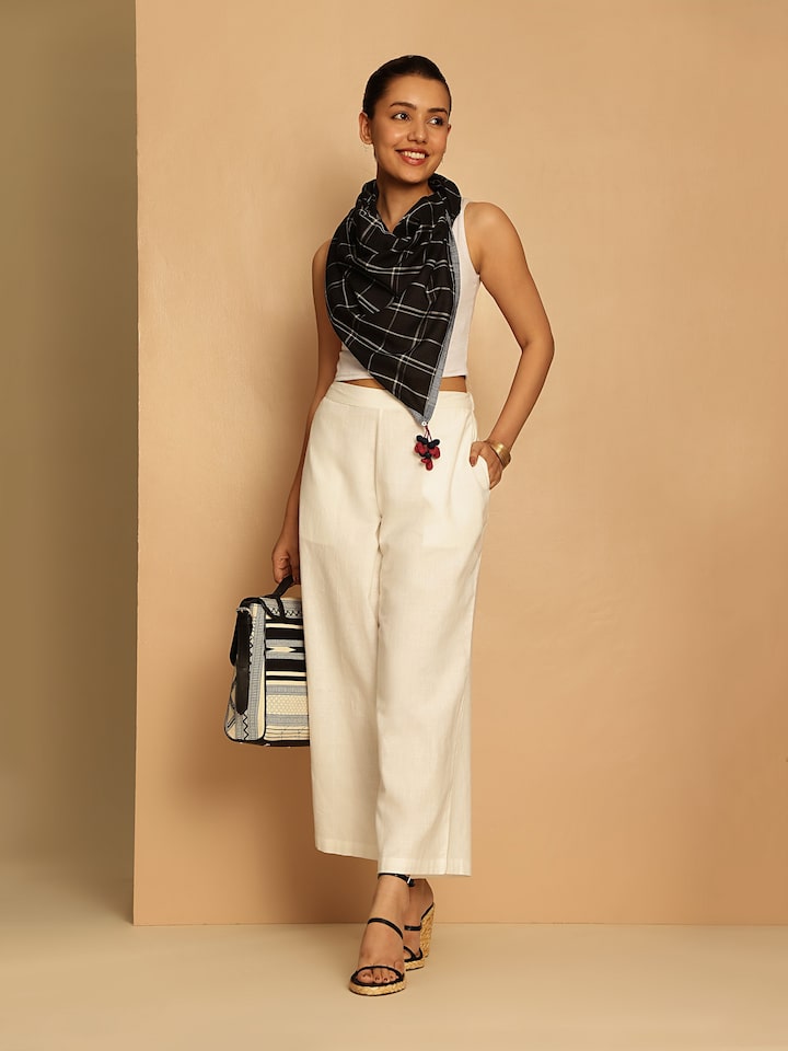 Side view of white cotton hand-spun palazzos highlighting straight fall and comfort fit