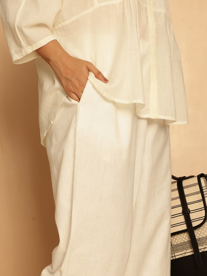 Detail view of white cotton hand-spun palazzos showcasing fabric softness and craftsmanship
