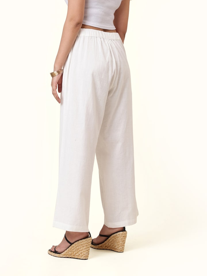 Back view of white cotton hand-spun palazzos displaying clean finish and full length fit
