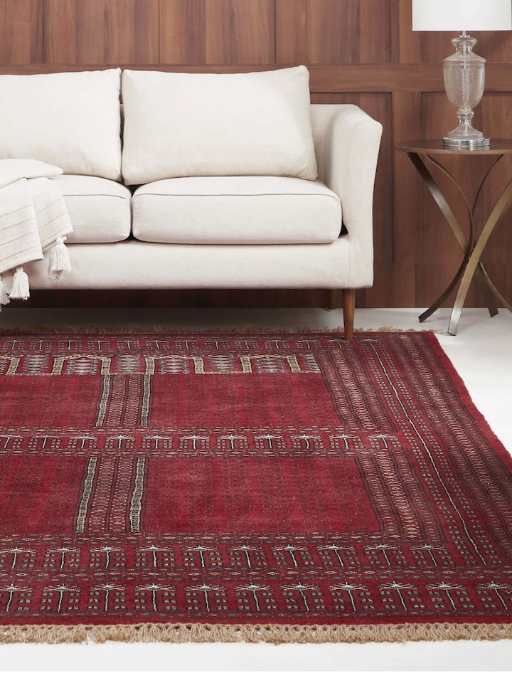 Interior view featuring Amritsari Parda rug in deep red tones, hand-knotted in Gwalior with intricate design patterns.