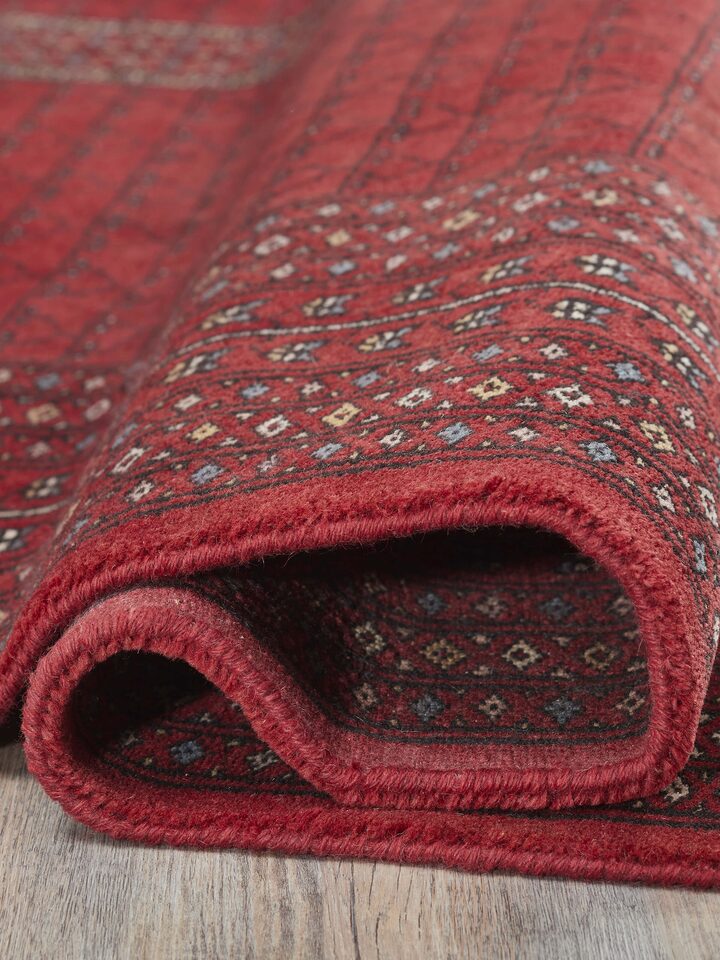 Detailed view of the Amritsari Parda red Gwalior rug showcasing the wool texture and hand-knotted craftsmanship