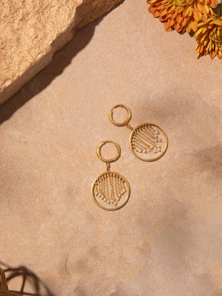 Styled detail view of Silver Smithing Drop Earrings worn on the ear, shown in another styled shot