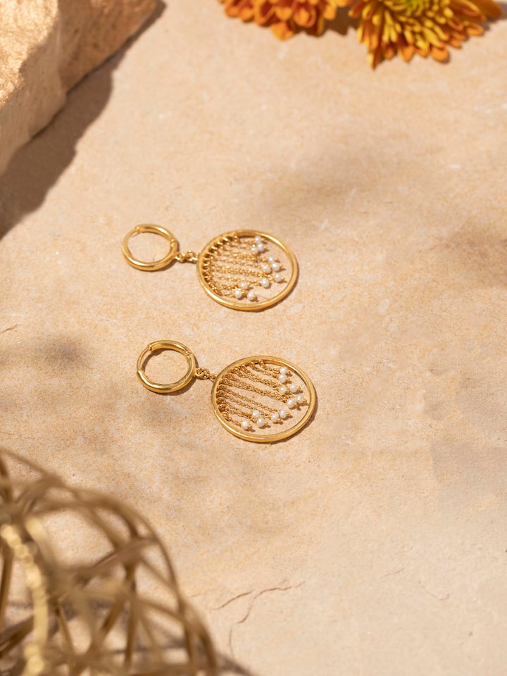 Styled detail view of Silver Smithing Drop Earrings worn on the ear, shown in an alternate styled shot