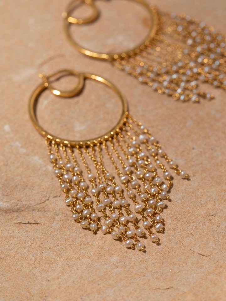Detailed close-up of silver smithing hoops focusing on their design and texture