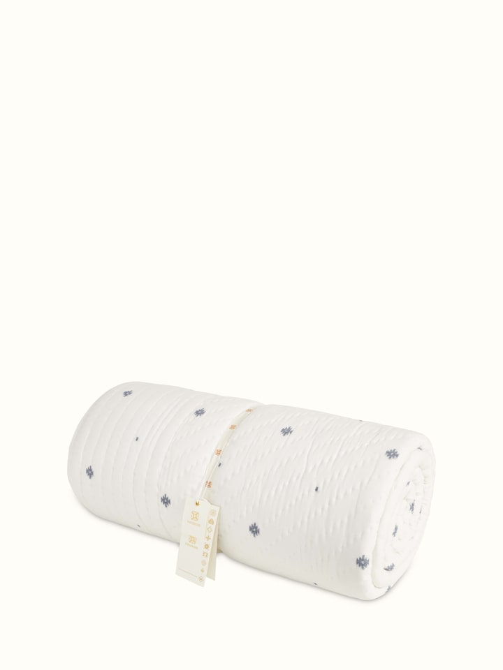Detailed view of Kalpanama ivory woven buti cotton quilt double, highlighting the texture and craftsmanship.