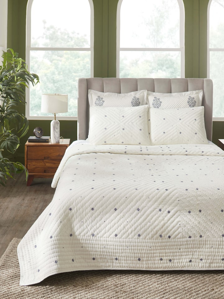 Close-up view of Kalpanama ivory woven buti cotton quilt double, focusing on the detailed weaving and pattern.
