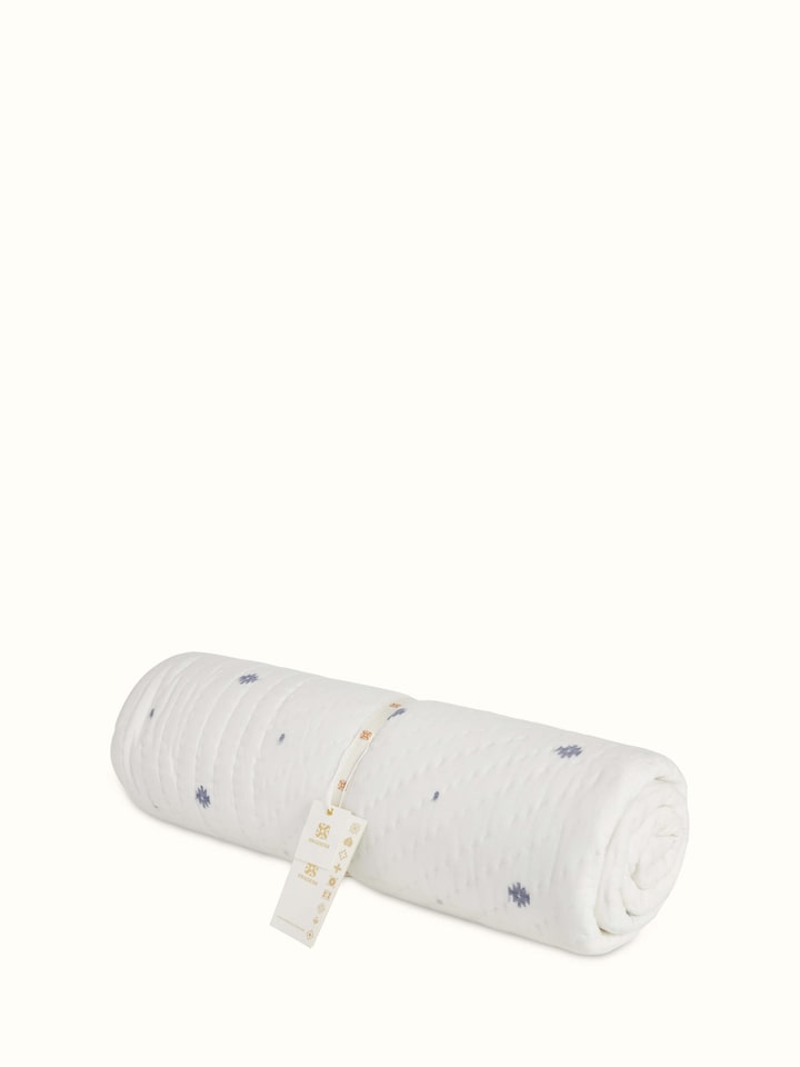 Kalpanama Ivory Woven Buti Cotton Single Quilt displayed on a bed, emphasizing its design and coverage.
