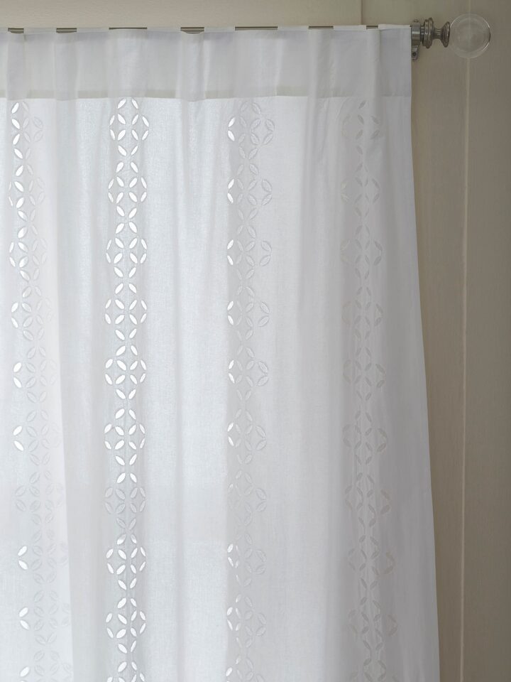 Detail shot of Mandana white sheer curtain with trellis stripes and cotton applique, capturing the fabric's texture.