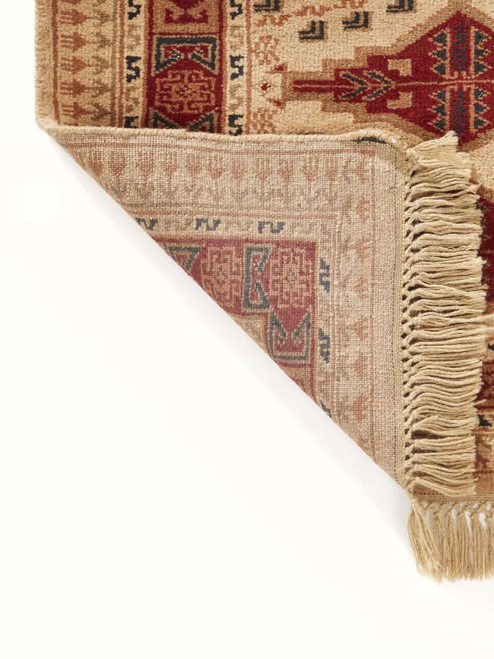Angled view of Traditional Persian Shiraz Beige Rust Gwalior Wool Hand-Knotted Runner showing the pattern in context