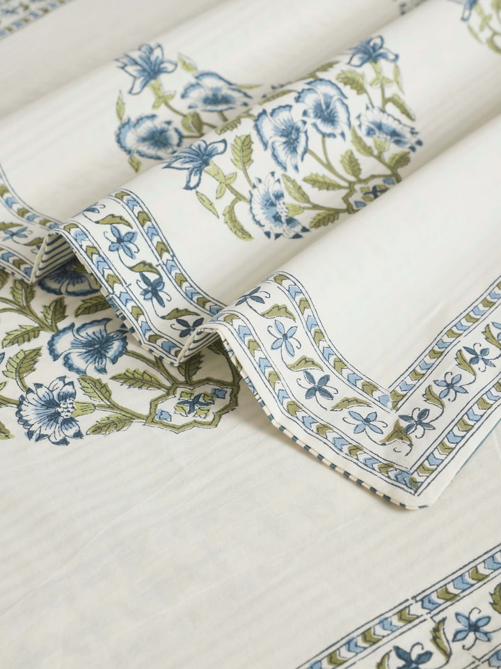 Side view of Aarunya blue buta cotton Sanganeri block printed queen bedsheet set displayed on a bed