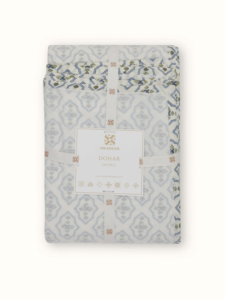 Close-up of Aarunya blue trellis cotton double dohar with focus on the Sanganeri block print and fabric texture.