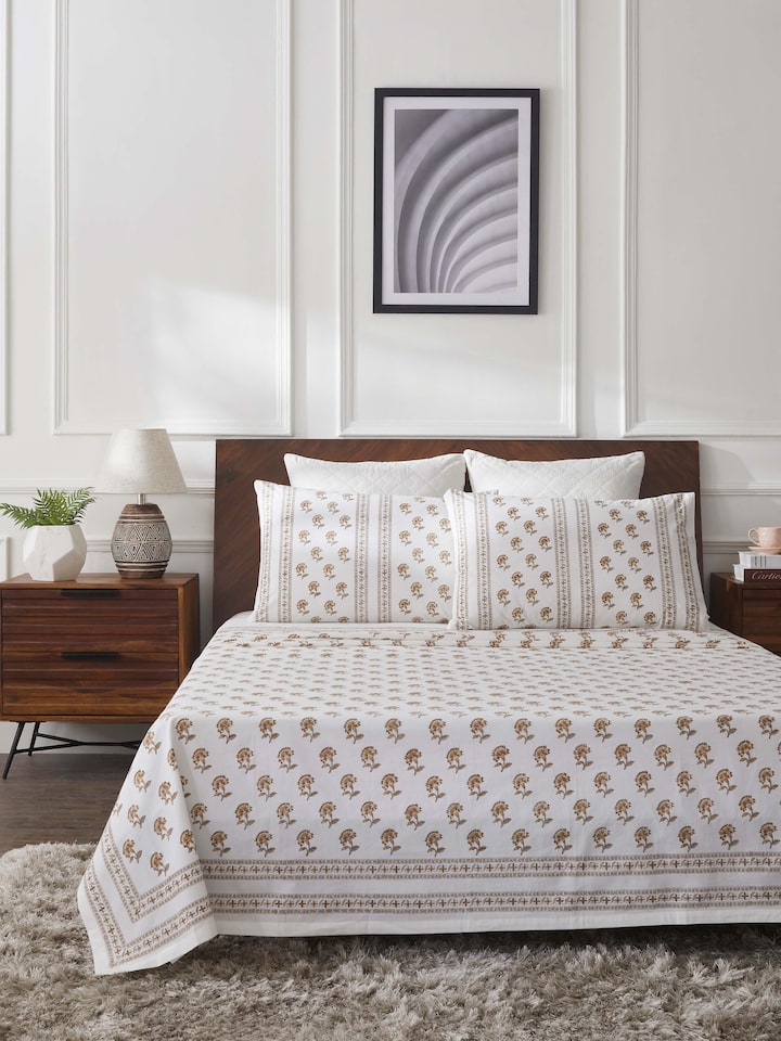 Close-up of Aarunya beige buti cotton Sanganeri block printed king bedsheet set, focusing on the intricate block prints and fabric quality.