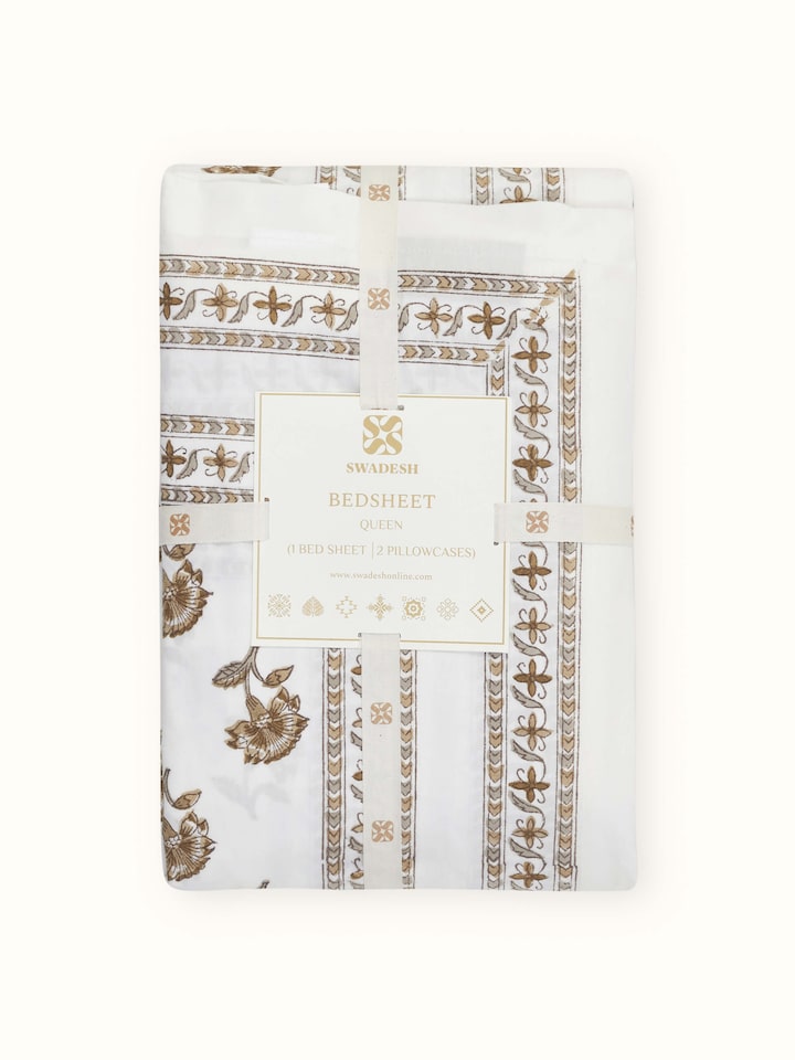 Aarunya beige buti cotton Sanganeri block printed queen bedsheet set, displayed on a bed to show the complete set in use.