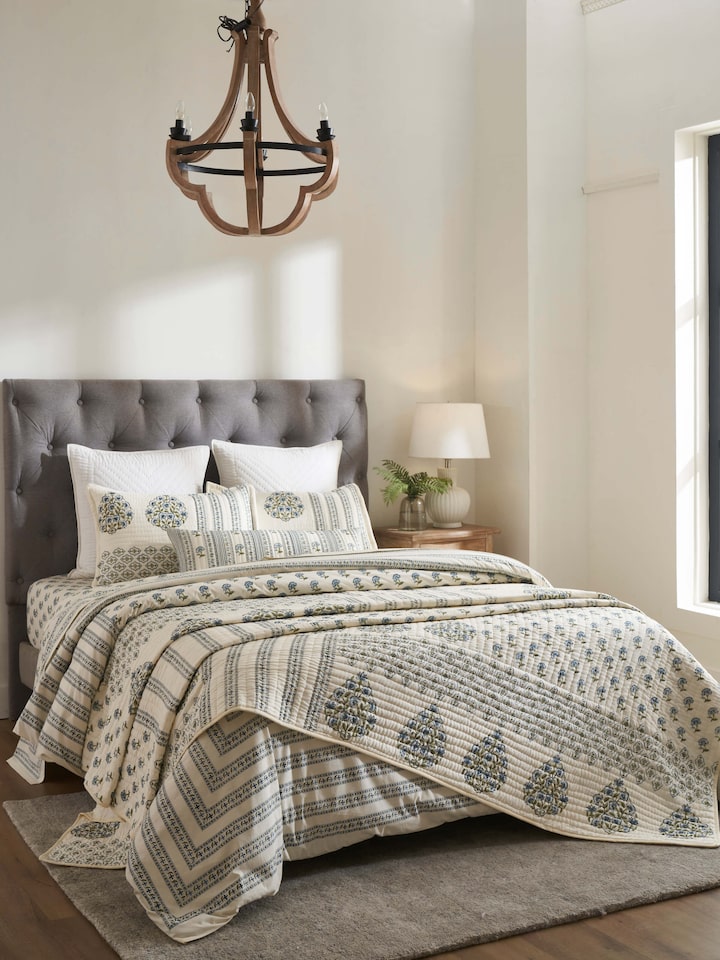 Side view of Aarunya Blue Floral Cotton Sanganeri Block Printed Double Quilt highlighting the quilt's thickness and edge.