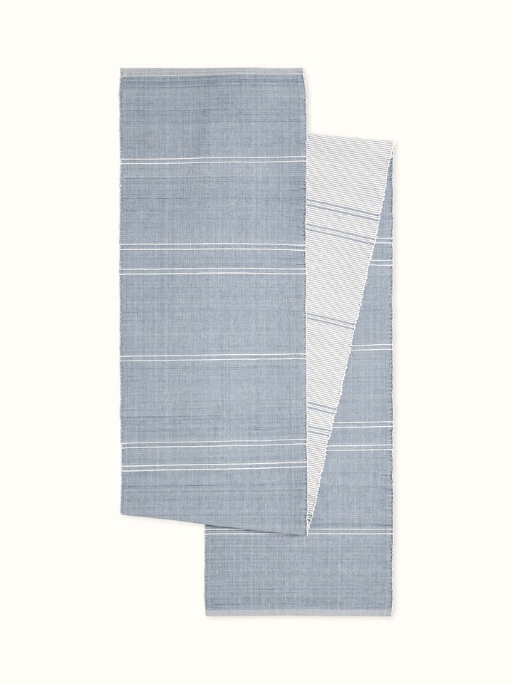 Front view: Front view of Vastav cotton handloom table runner in light blue stripes for 6-seater dining table.