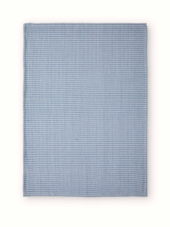 Close-up of Arth light blue handwoven cotton dish towels displaying the weave pattern and light blue shade.