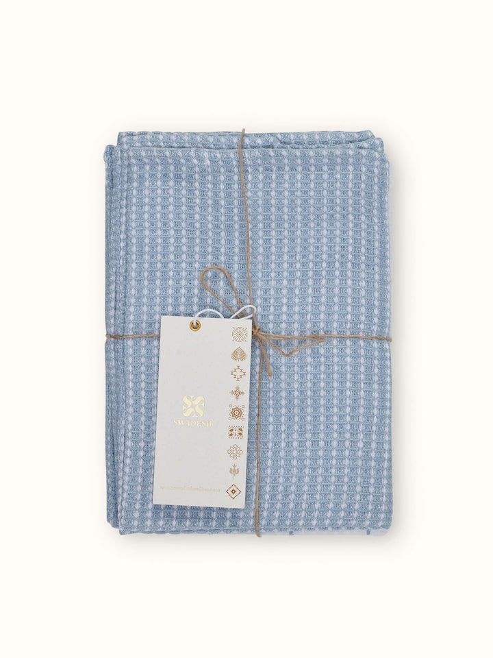 Detailed view of Arth light blue handwoven cotton dish towels highlighting the handwoven texture and light blue hue.