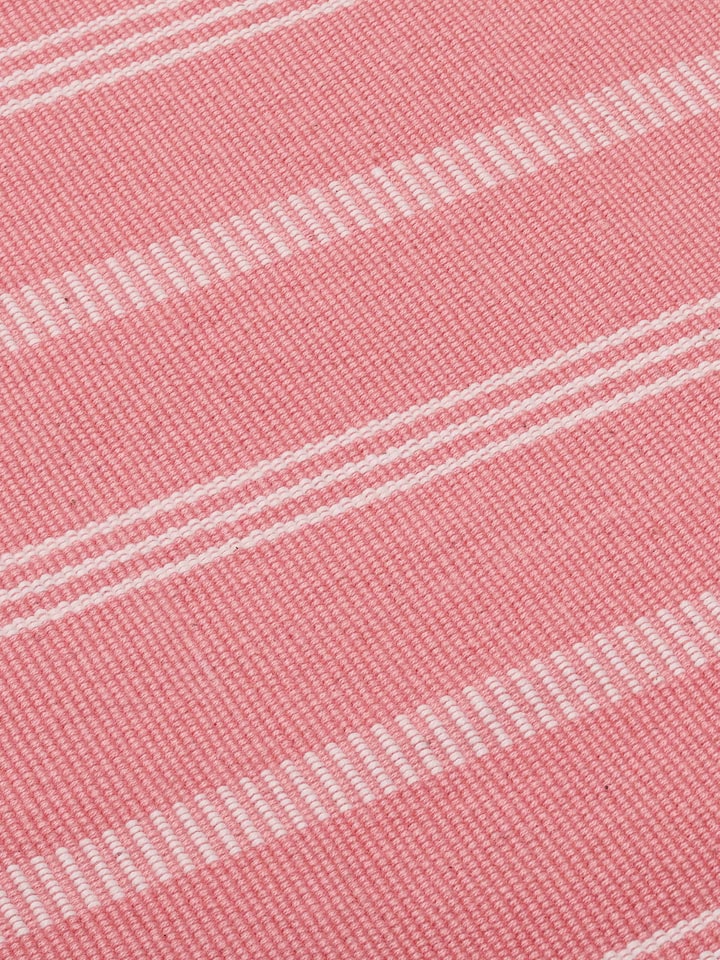 A side profile view of the Vastav Pink Stripe Cotton Handloom Table Runner, capturing the runner’s drape, fabric weight, and handwoven pink stripe design by Swadesh.