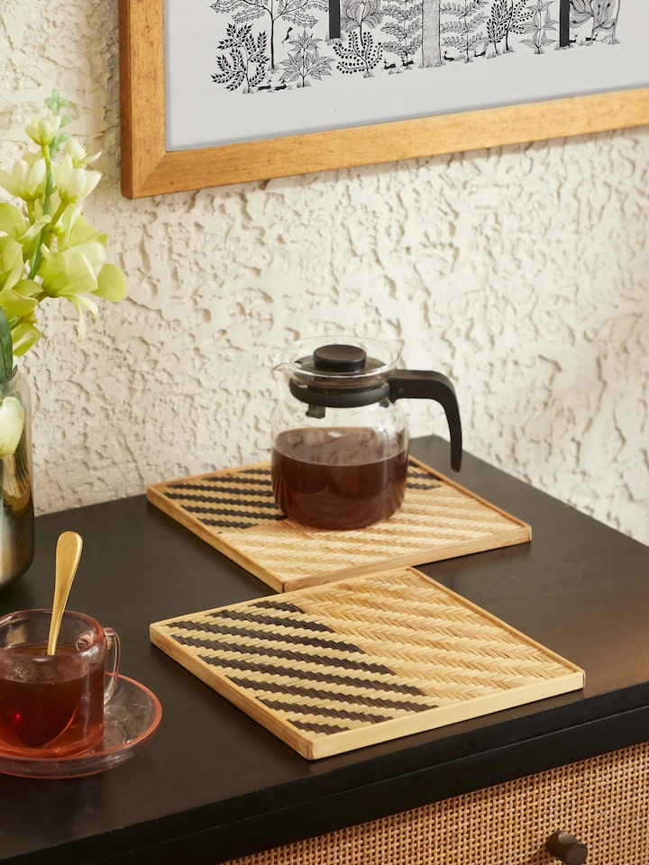 Close-up of Naveena grey geometric square natural fibre trivets (2 pcs) highlighting the geometric patterns and natural fiber material