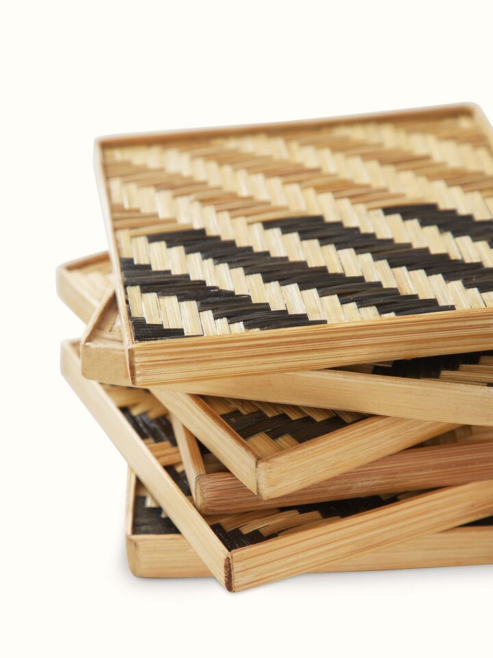 Perspective view of Naveena grey geometric square natural fibre coasters (6 pcs) showing the full set and their geometric design.