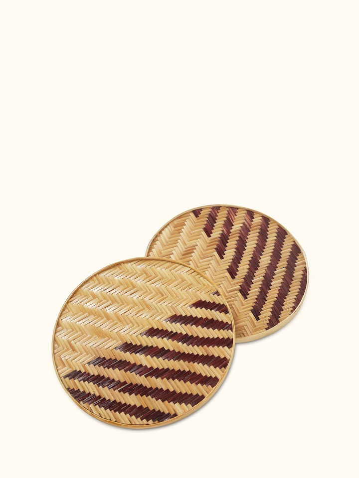 Naveena brown geometric round natural fibre trivet, showing the textured design and natural fiber material