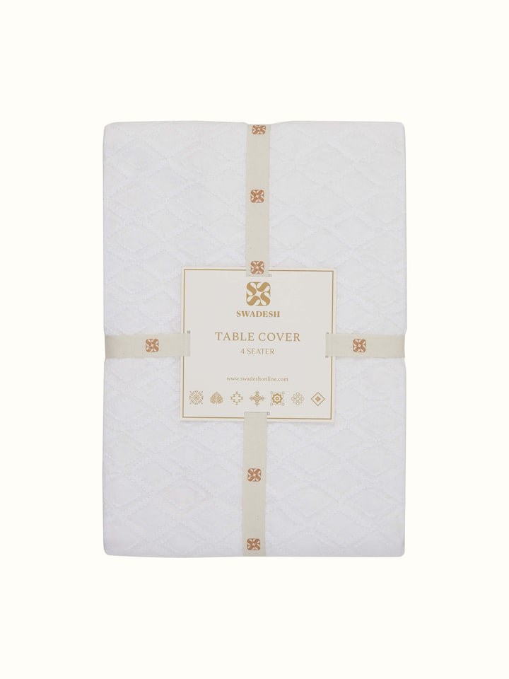 Ananda white geometric cotton Chikankari table cover (4 seater) in a setting that emphasizes its use and design.