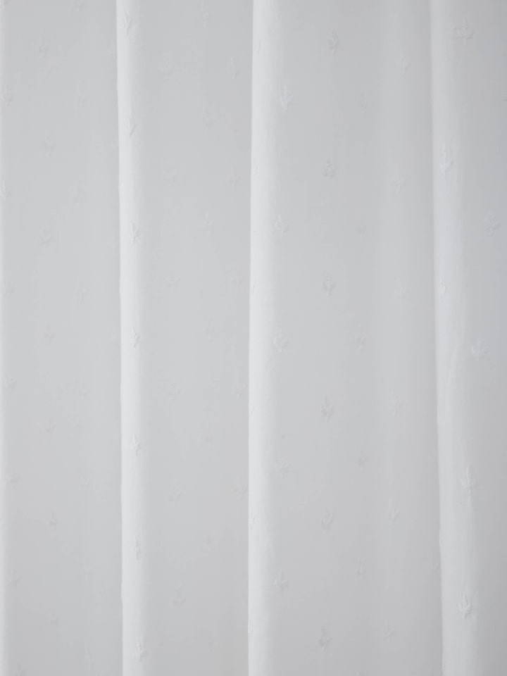 Side view of Svetah White Trellis Silk Cotton Chikankari Sheer Curtain emphasizing its delicate chikankari embroidery.