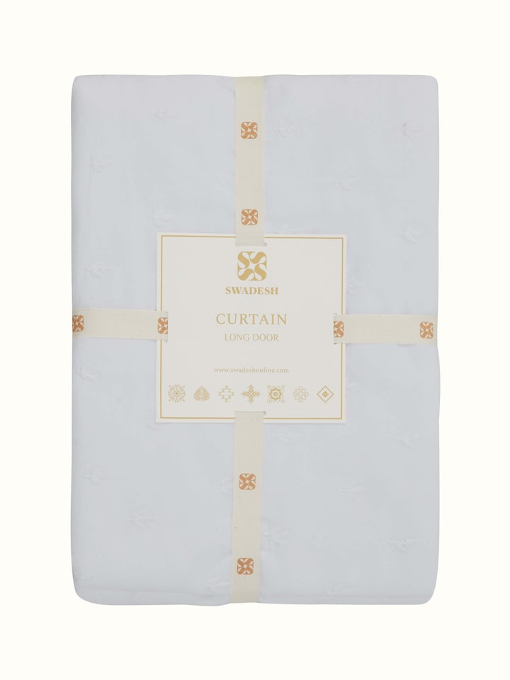 Angled view of Svetah White Trellis Silk Cotton Chikankari Sheer Curtain showcasing its sheer fabric and trellis design.