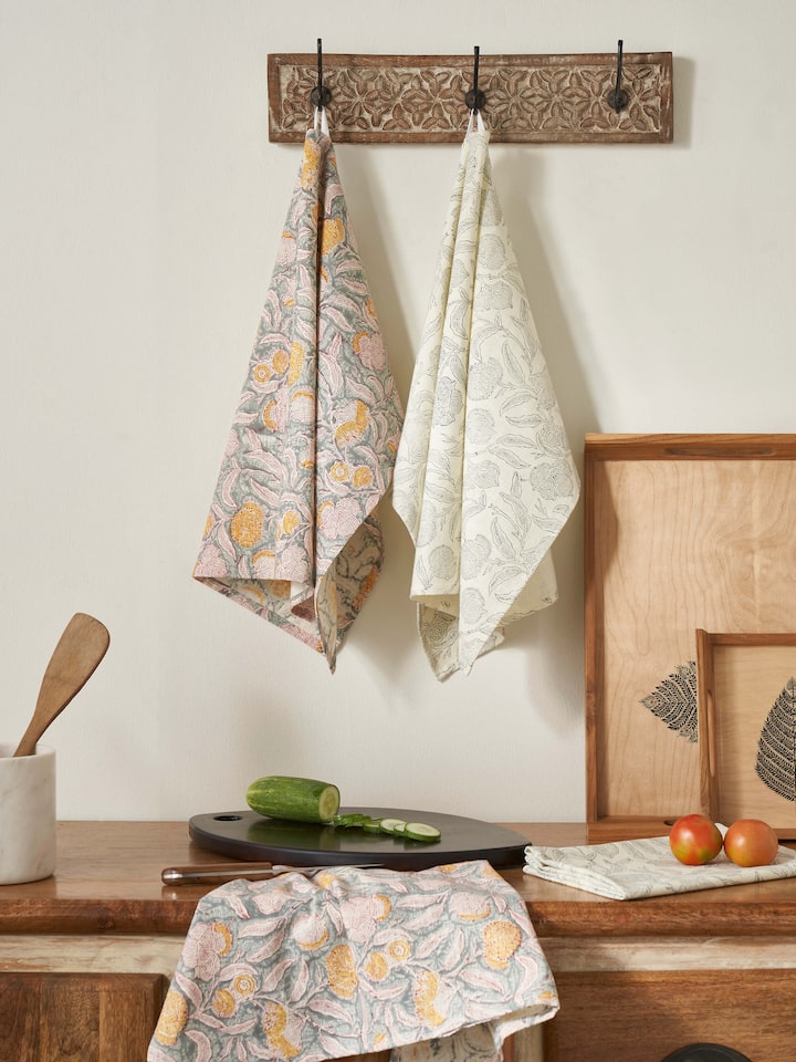 Close-up of Samaha grey floral dish towels showcasing the block print design and cotton material.