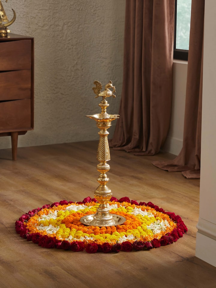 Side view of Polished brass vilakku stand diya showcasing the detailed brasswork and decorative elements