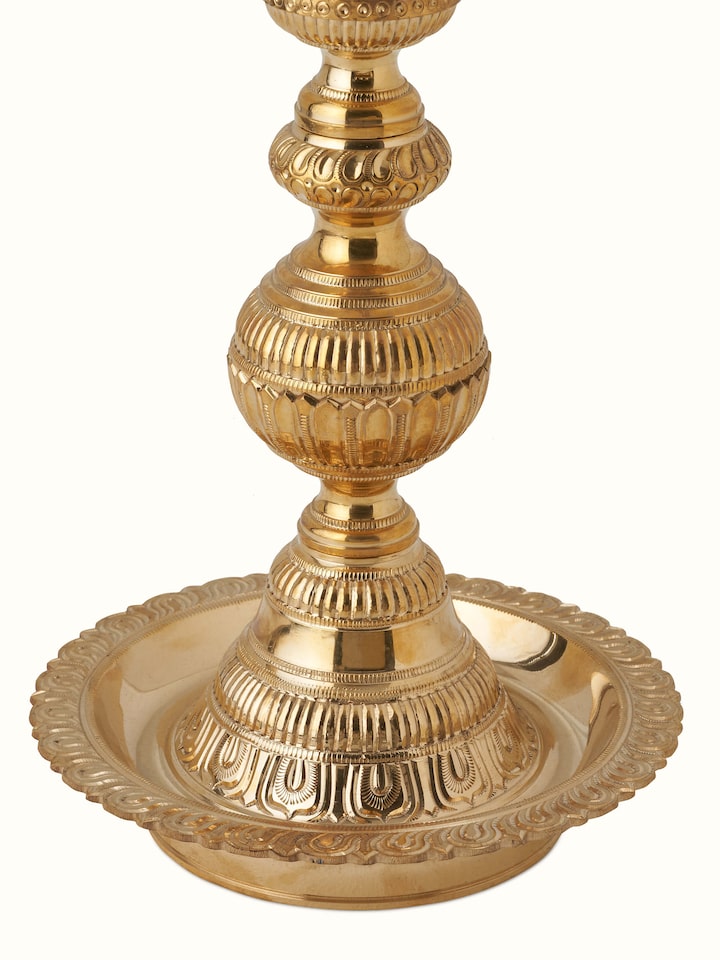 Close-up view of Polished brass vilakku stand diya, showcasing the fine brasswork and intricate patterns