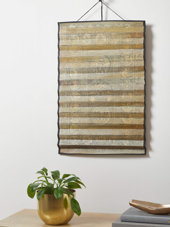 Side view of Palm leaf engraved lord Krishna narrative wall art with detailed carving